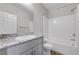 Bathroom with granite countertop, white cabinets and tub shower combo at 7505 Emerald Stars St # 101, North Las Vegas, NV 89084
