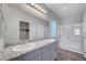 Bathroom with double sink vanity, granite countertop and glass enclosed shower at 7505 Emerald Stars St # 101, North Las Vegas, NV 89084