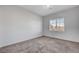 Bedroom with plush carpet and window at 7505 Emerald Stars St # 101, North Las Vegas, NV 89084