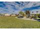 Expansive community park with lush green lawns, walking paths, and desert landscaping on a partly cloudy day at 7505 Emerald Stars St # 101, North Las Vegas, NV 89084