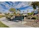 Inviting community park with walking path and bench seating amidst desert landscaping under a partly cloudy sky at 7505 Emerald Stars St # 101, North Las Vegas, NV 89084
