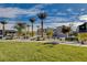 A view of a community park with green lawns, desert landscaping, a picnic pavilion and walking trails at 7505 Emerald Stars St # 101, North Las Vegas, NV 89084
