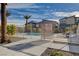 Gated community pool surrounded by desert landscaping and modern townhomes under a partly cloudy sky at 7505 Emerald Stars St # 101, North Las Vegas, NV 89084