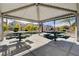 A community space featuring picnic tables under a covered pavilion, surrounded by landscaping and neighborhood homes at 7505 Emerald Stars St # 101, North Las Vegas, NV 89084