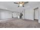 Open living space with a kitchen, ceiling fan, and neutral tones at 7505 Emerald Stars St # 101, North Las Vegas, NV 89084