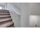 Carpeted staircase with a white handrail at 7505 Emerald Stars St # 101, North Las Vegas, NV 89084
