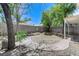Spacious backyard with mature trees, brick border, and block wall for privacy at 7865 March Brown Ave, Las Vegas, NV 89149