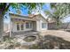 Backyard with covered patio, fire pit, and well-maintained block wall at 7865 March Brown Ave, Las Vegas, NV 89149