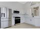 Bright kitchen boasts stainless steel appliances, white cabinetry, and a modern design at 7865 March Brown Ave, Las Vegas, NV 89149