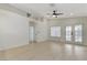 Bright living room with vaulted ceilings, hardwood floors, double doors to backyard and stylish ceiling fan at 7865 March Brown Ave, Las Vegas, NV 89149