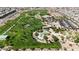 Beautiful aerial view of park featuring green spaces, playground, tennis courts and swimming pool at 789 Drammatico Pl, Henderson, NV 89011