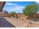 Backyard with pavers, gravel, mature landscaping, and block wall fencing at 789 Drammatico Pl, Henderson, NV 89011