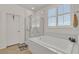 Relaxing bathroom with a soaking tub, separate glass-enclosed shower, and a bright, airy atmosphere at 789 Drammatico Pl, Henderson, NV 89011