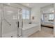Bathroom featuring a glass-enclosed shower and a separate soaking tub at 789 Drammatico Pl, Henderson, NV 89011