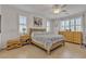 Serene bedroom featuring large windows, a ceiling fan, and a comfortable bed for a restful night's sleep at 789 Drammatico Pl, Henderson, NV 89011