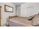 Comfortable bedroom featuring earth tone color palette, plush pillows, and a full length mirror at 789 Drammatico Pl, Henderson, NV 89011