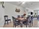 Bright dining room featuring elegant dark wood table, matching chairs and decor at 789 Drammatico Pl, Henderson, NV 89011