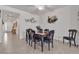 Well-lit dining room featuring a dark wood table, seating for six, and stylish decor at 789 Drammatico Pl, Henderson, NV 89011