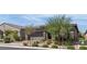 Low angle showing the front of a single-story house with manicured landscaping, brick driveway, and a two-car garage at 789 Drammatico Pl, Henderson, NV 89011