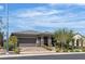 Beautiful single-story house with manicured landscaping, brick driveway, and a two-car garage at 789 Drammatico Pl, Henderson, NV 89011