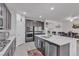 Stylish kitchen with stainless steel appliances, a large island, barstool seating, and modern amenities at 789 Drammatico Pl, Henderson, NV 89011