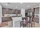 Modern kitchen featuring stainless steel appliances, a large island, and bar stool seating at 789 Drammatico Pl, Henderson, NV 89011