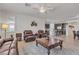 Inviting living room with tile floors, ceiling fan, and an open layout that flows into the kitchen and dining areas at 789 Drammatico Pl, Henderson, NV 89011
