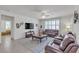 Bright living room offers comfortable seating, a ceiling fan, and plenty of natural light from large windows at 789 Drammatico Pl, Henderson, NV 89011