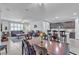 Spacious open-concept area with a dining area, bar seating, and comfortable living room at 789 Drammatico Pl, Henderson, NV 89011