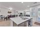 Bright and airy open concept featuring a large kitchen island, dining area, and living room at 789 Drammatico Pl, Henderson, NV 89011
