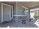 Cozy front porch with two chairs and decorative stone accents adds charm to this home at 789 Drammatico Pl, Henderson, NV 89011