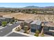 Wide aerial shot featuring a desert landscape and neat street lined with modern homes at 8261 Selenite St, Las Vegas, NV 89113