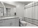 Bathroom with white cabinets, granite counters, a large mirror, and a shower with a curtain at 8261 Selenite St, Las Vegas, NV 89113
