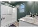 Bathroom featuring a glass shower, granite vanity and large window at 8261 Selenite St, Las Vegas, NV 89113