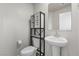 Clean half bathroom with a modern pedestal sink, minimalist fixtures, and a neutral color scheme at 8261 Selenite St, Las Vegas, NV 89113