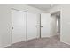 This bedroom features neutral walls, carpet flooring, and a double-door closet for ample storage at 8261 Selenite St, Las Vegas, NV 89113