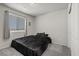 This bedroom features a large window, gray walls, and a comfy bed at 8261 Selenite St, Las Vegas, NV 89113
