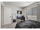 Bedroom with a bed, mirror, and window with natural light, desk and chair at 8261 Selenite St, Las Vegas, NV 89113