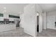 Inviting entryway featuring stylish kitchen with white cabinets, granite counters, stainless appliances and a clean color palette at 8261 Selenite St, Las Vegas, NV 89113