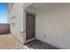 Home entryway featuring a gray front door with a keypad lock and stone detailing at 8261 Selenite St, Las Vegas, NV 89113