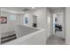 Bright hallway with view to office and bedroom from the stairway landing at 8261 Selenite St, Las Vegas, NV 89113