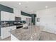 Kitchen features stainless steel appliances, granite countertops, and an island with a sink at 8261 Selenite St, Las Vegas, NV 89113