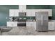 Stylish kitchen with granite countertops, stainless steel appliances, and white cabinets provides ample counter space at 8261 Selenite St, Las Vegas, NV 89113
