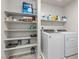 Convenient laundry room featuring modern washer/dryer set and shelving for storage at 8261 Selenite St, Las Vegas, NV 89113