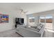 Cozy living room featuring a sectional sofa, tile floors, and sliding glass doors to the backyard at 8261 Selenite St, Las Vegas, NV 89113