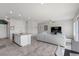 Open-concept living room features a modern kitchen island, a comfortable sofa, and neutral color palette at 8261 Selenite St, Las Vegas, NV 89113