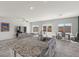 Bright open-concept living space with tile floors, a kitchen island, living room, and dining area at 8261 Selenite St, Las Vegas, NV 89113