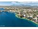 A calm lake scene with well manicured properties nearby and mountains in the distance at 8436 Kawala Dr, Las Vegas, NV 89128