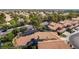 Aerial view of a residential area highlighting terracotta tile roofs, lush greenery, and well-maintained landscaping at 8436 Kawala Dr, Las Vegas, NV 89128
