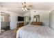 Spacious bedroom showcases a vaulted ceiling, a ceiling fan, and ample storage with wooden dressers at 8436 Kawala Dr, Las Vegas, NV 89128